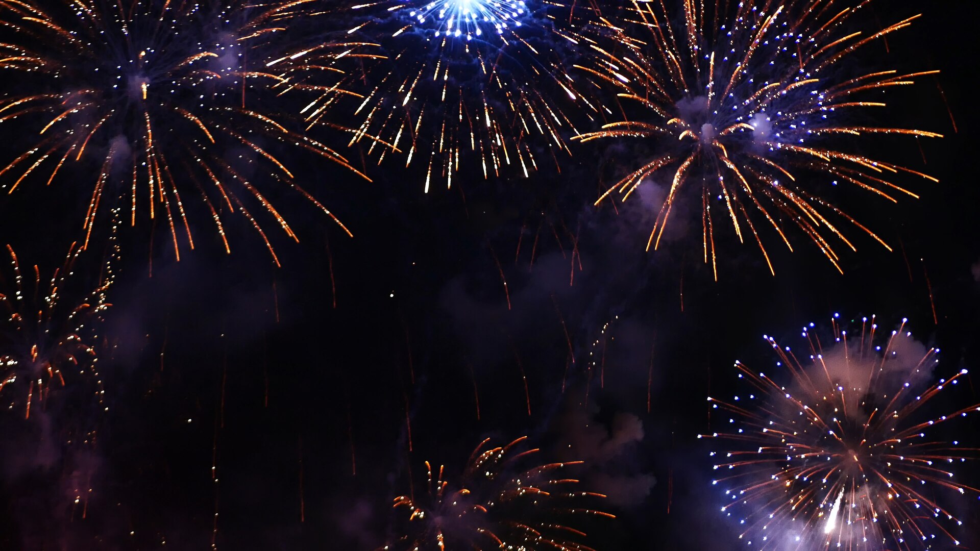 Golden and blue fireworks painting the night