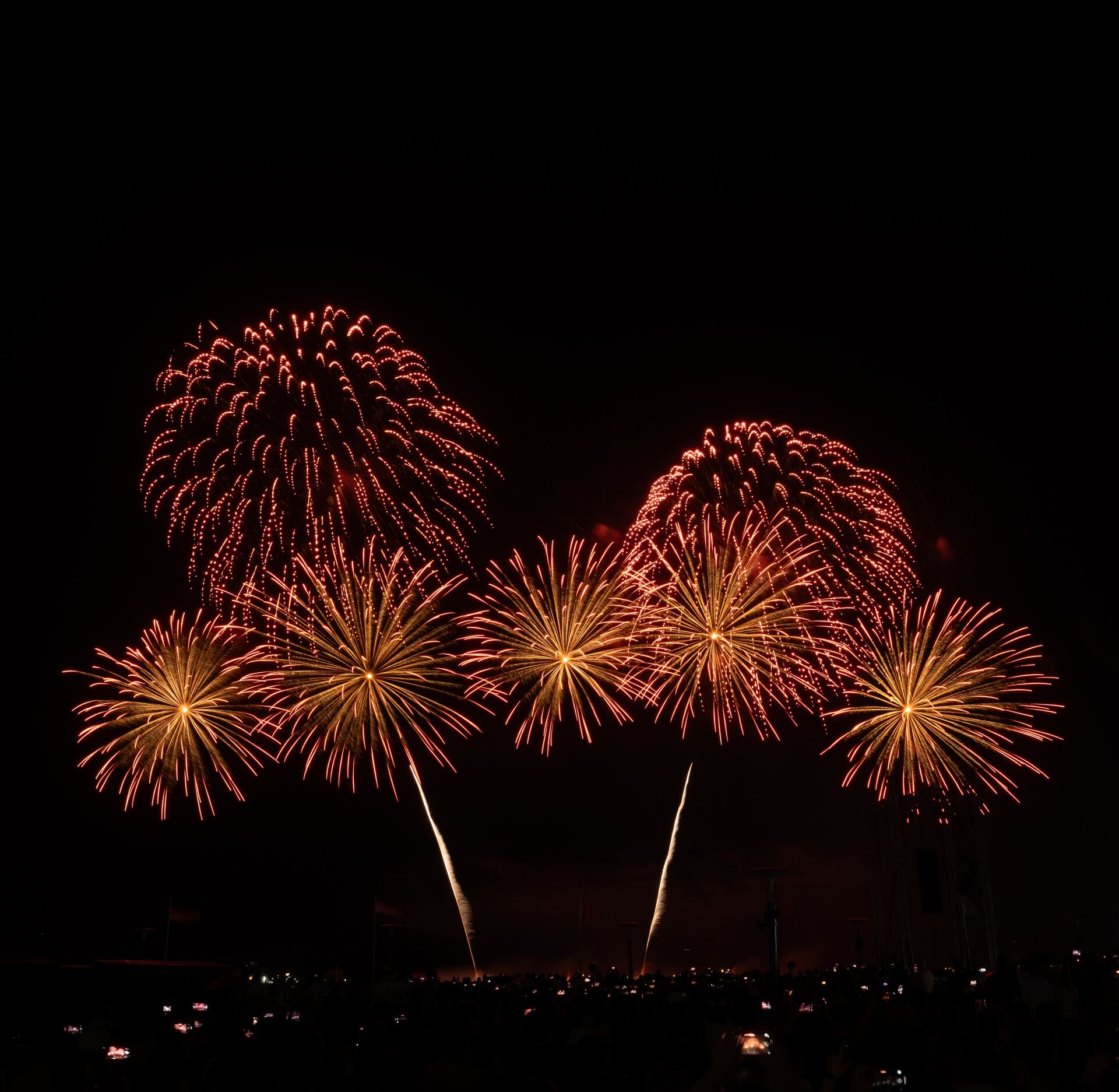Golden and red fireworks burst in darkness